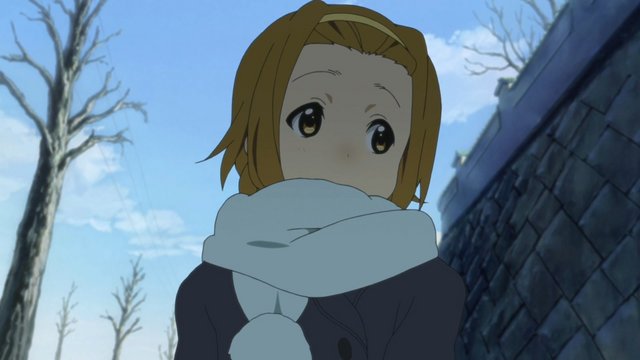 Yui and Ritsu catching snowflakes by the stone wall