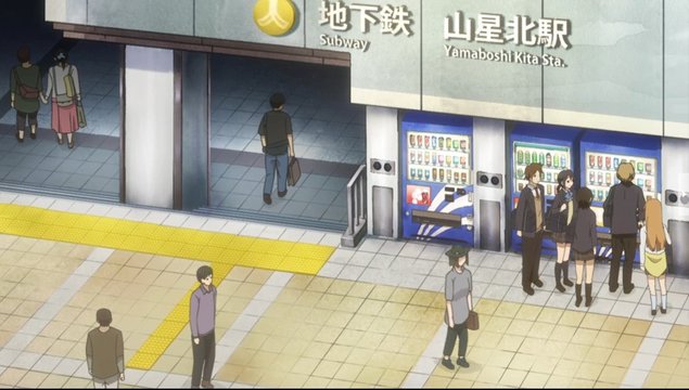 Taichi and Iori talking in front of the station