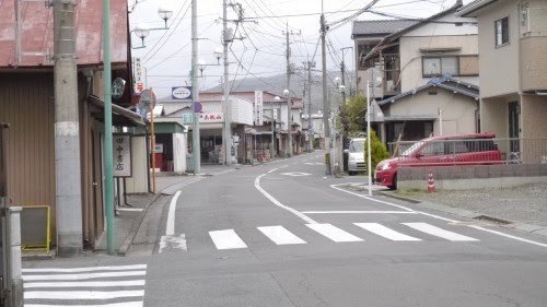 Kasuga Aoki walking alone on a residential street