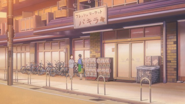 Rikka sitting in a shopping cart at supermarket entrance
