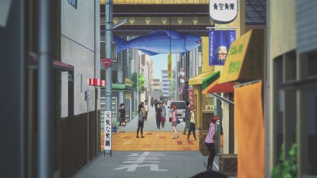 Tamako looks at the big whale at the entrance of the shopping street